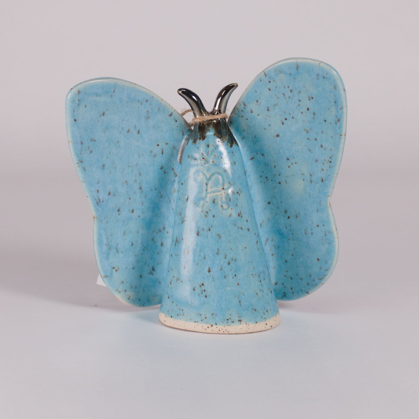 back view of Nana Abreu butterfly ceramic in blue